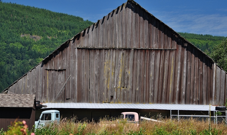 barn with trucks in front